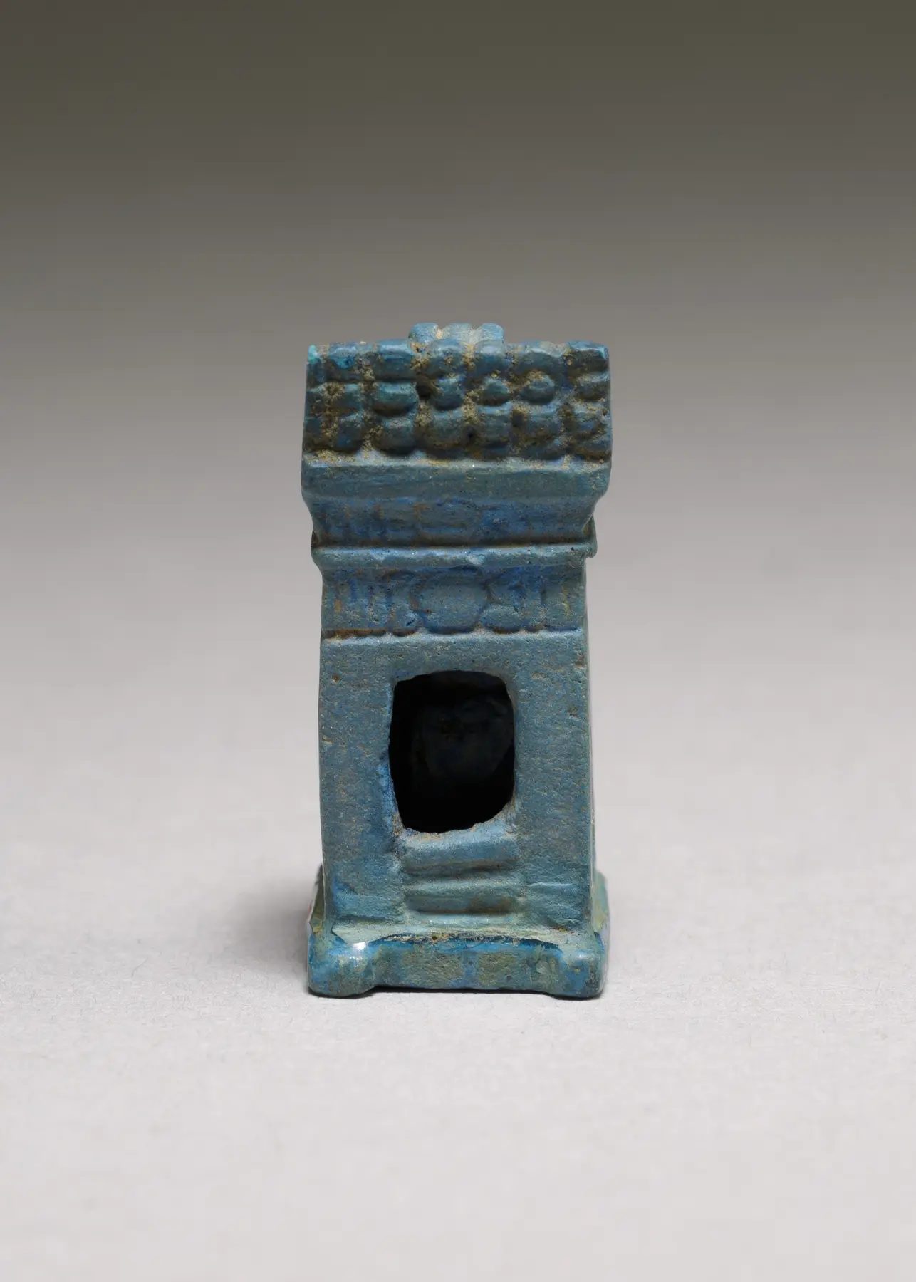 Khonsu shrine amulet, 2.5 cm tall, medium listed as Egyptian blue, Metropolitan Museum of Art 1984.177