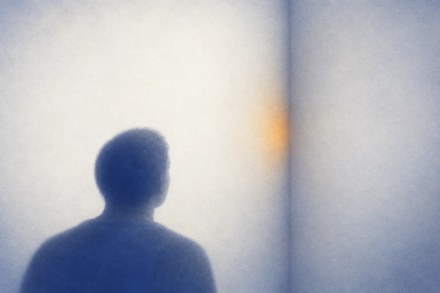 Illustration: a person seen from behind faces the inside corner of an empty room, its edges softly blurred